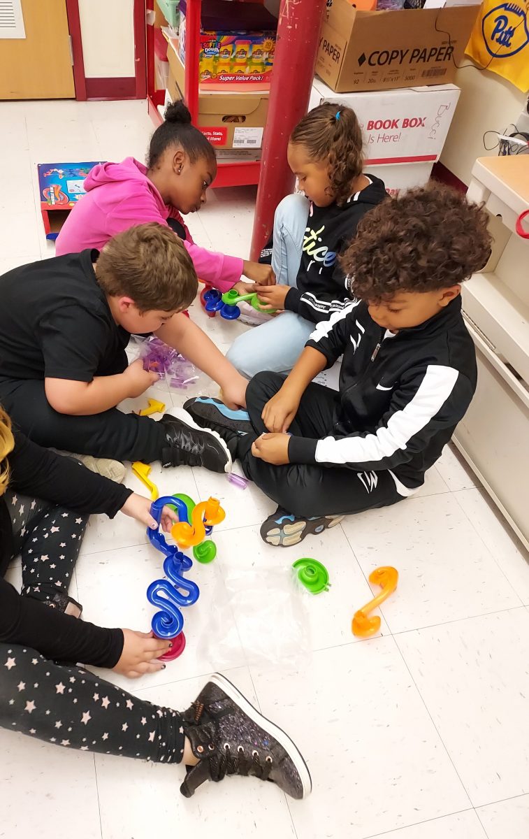 A group of Lockley students collaborating to create a marble run in their classroom